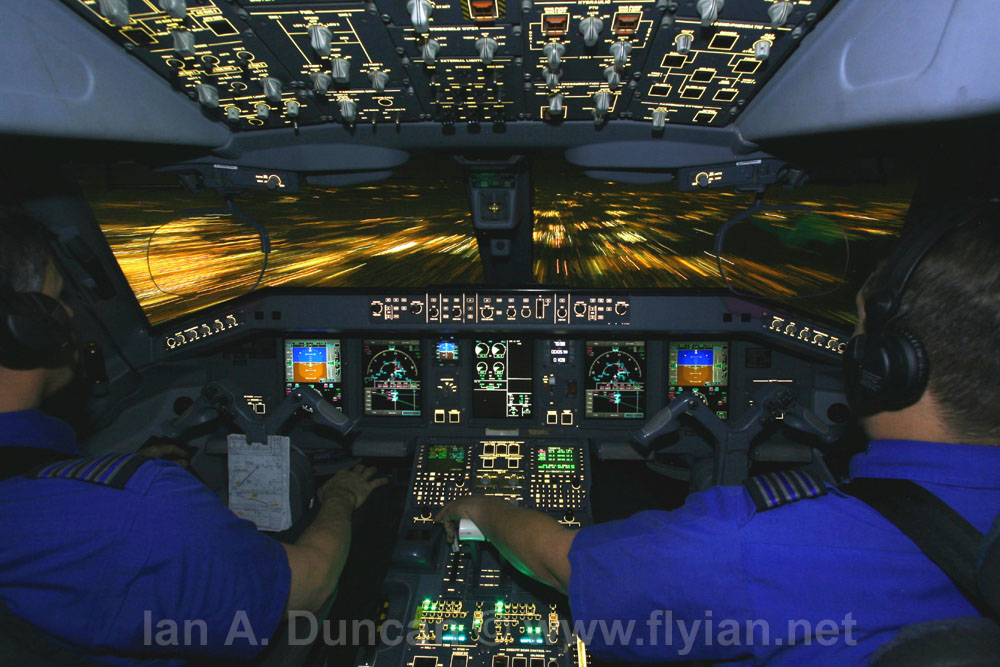 Ian & Bryan in E-190 cockpit at night