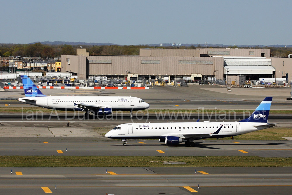 JetBlue A-320 N627JB lands while Embraer E-190 N267JB taxis